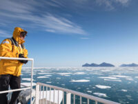 Quark Expeditions_Under the Northern Lights_pax_aboard_ship_ice_OCN_east_greenland_acacia johnson