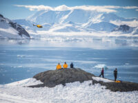 QuarkExpeditions_Exclusive-Heli-Landing_pax_landing_paradise_harbour_acaciajohnson_3